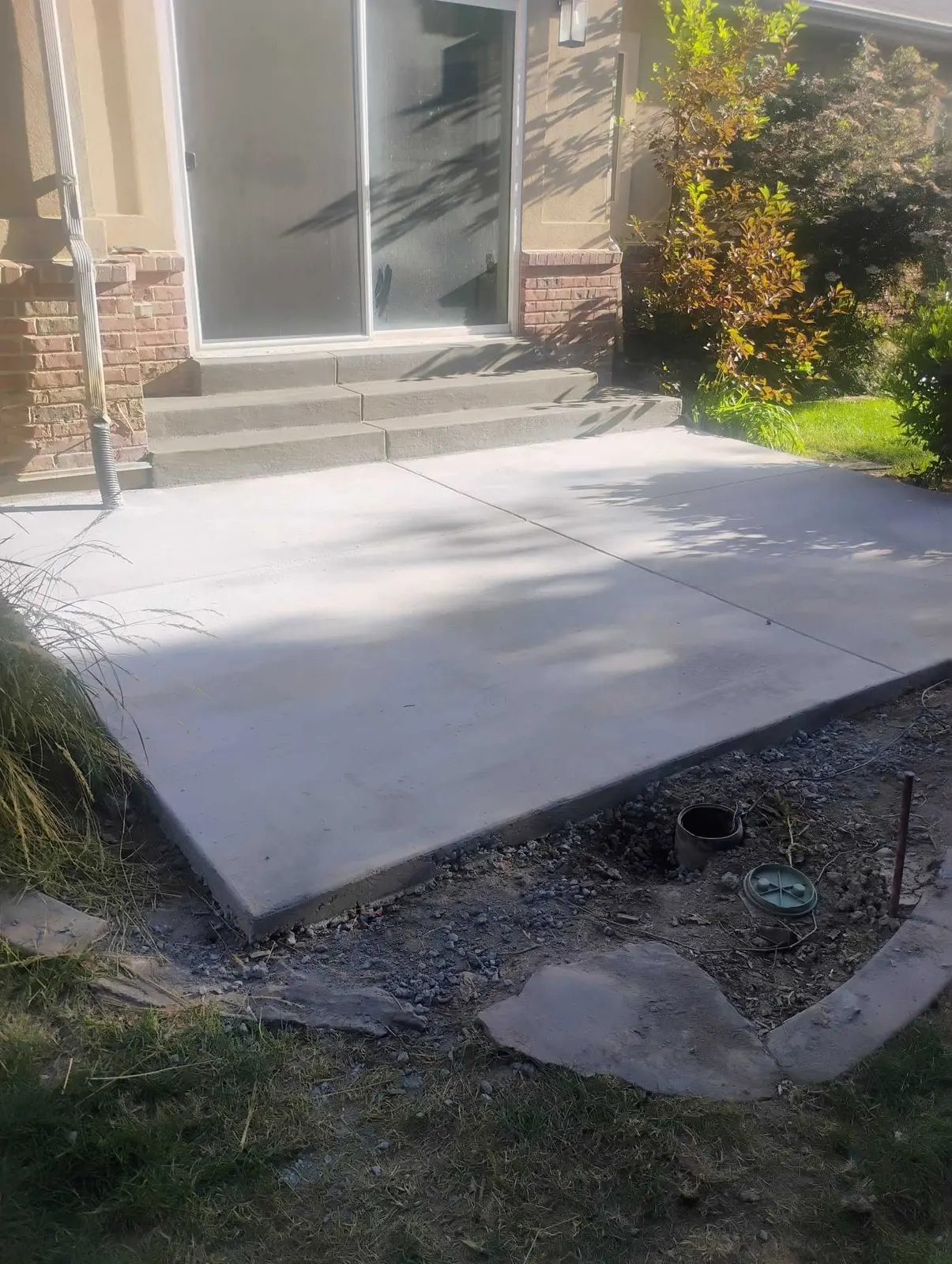 Completed concrete pad and walkway leading to a back entrance