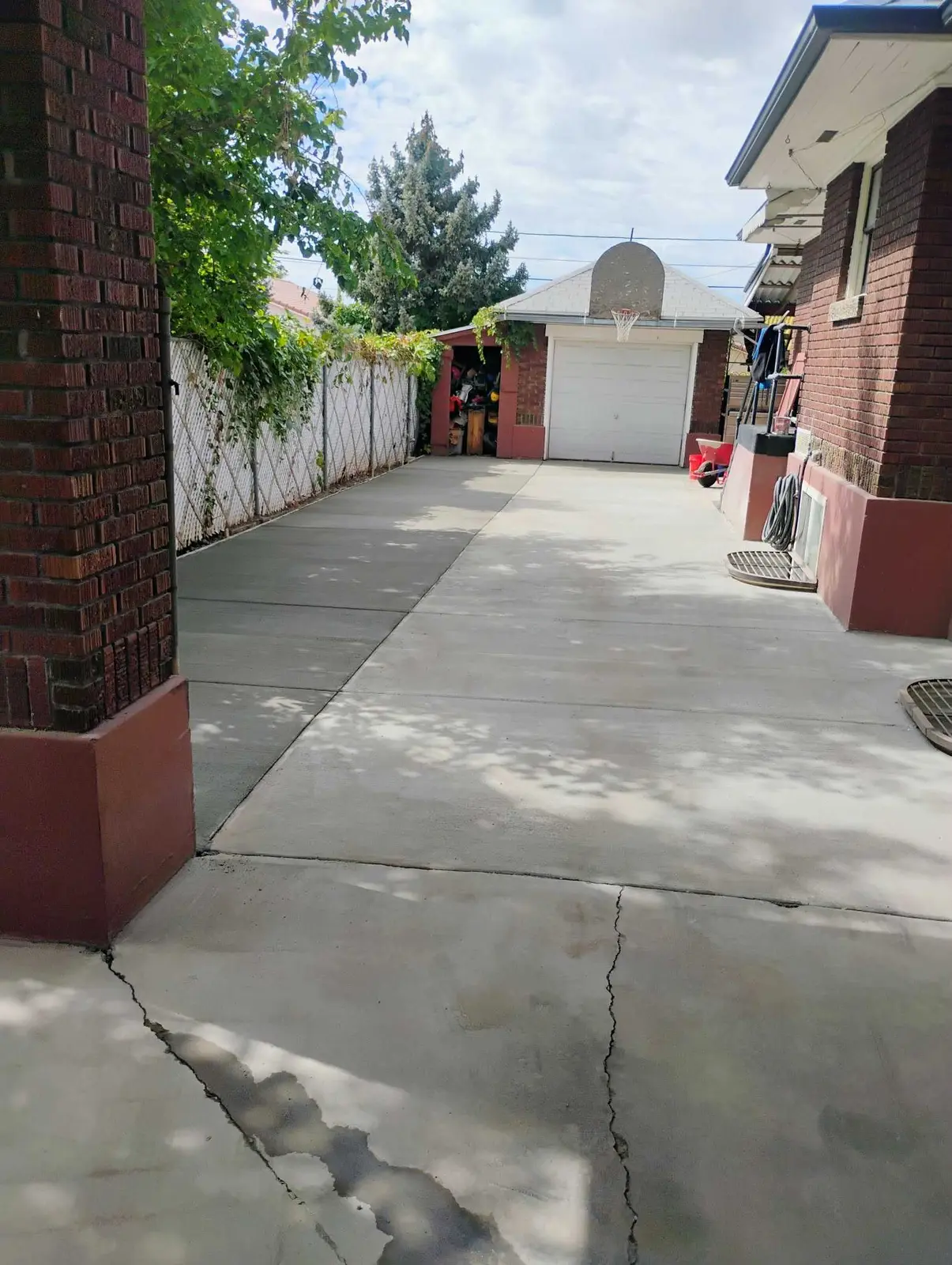 Long concrete driveway beside a brick home